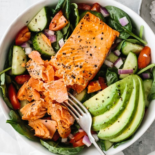 Salmon and Avocado over lettuce, tomato and cucumber